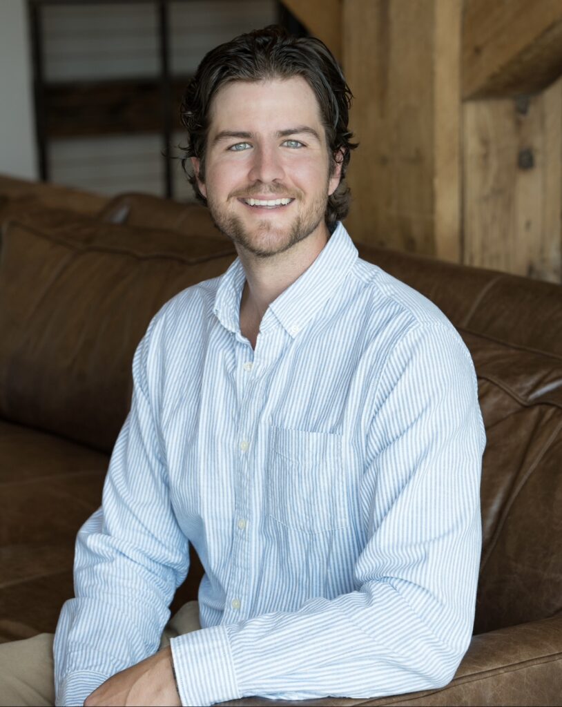 Nicely dressed office employee smiling for a headshot portrait.
