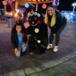 Family posing with gingerbread man.