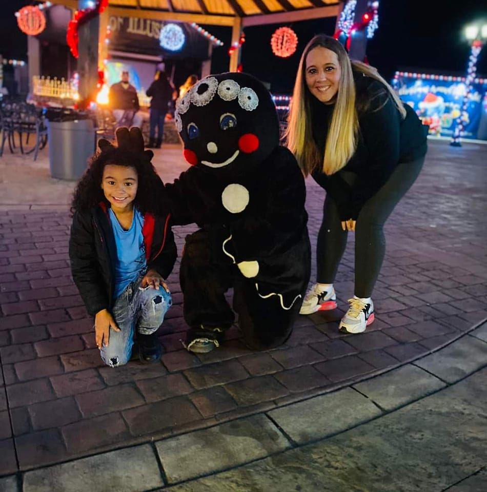 Family posing with gingerbread man.